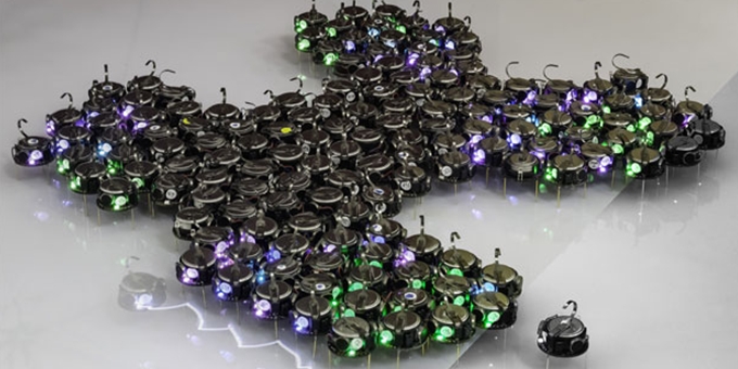Hundreds of Tiny Robots Grow Bio-inspired Shapes